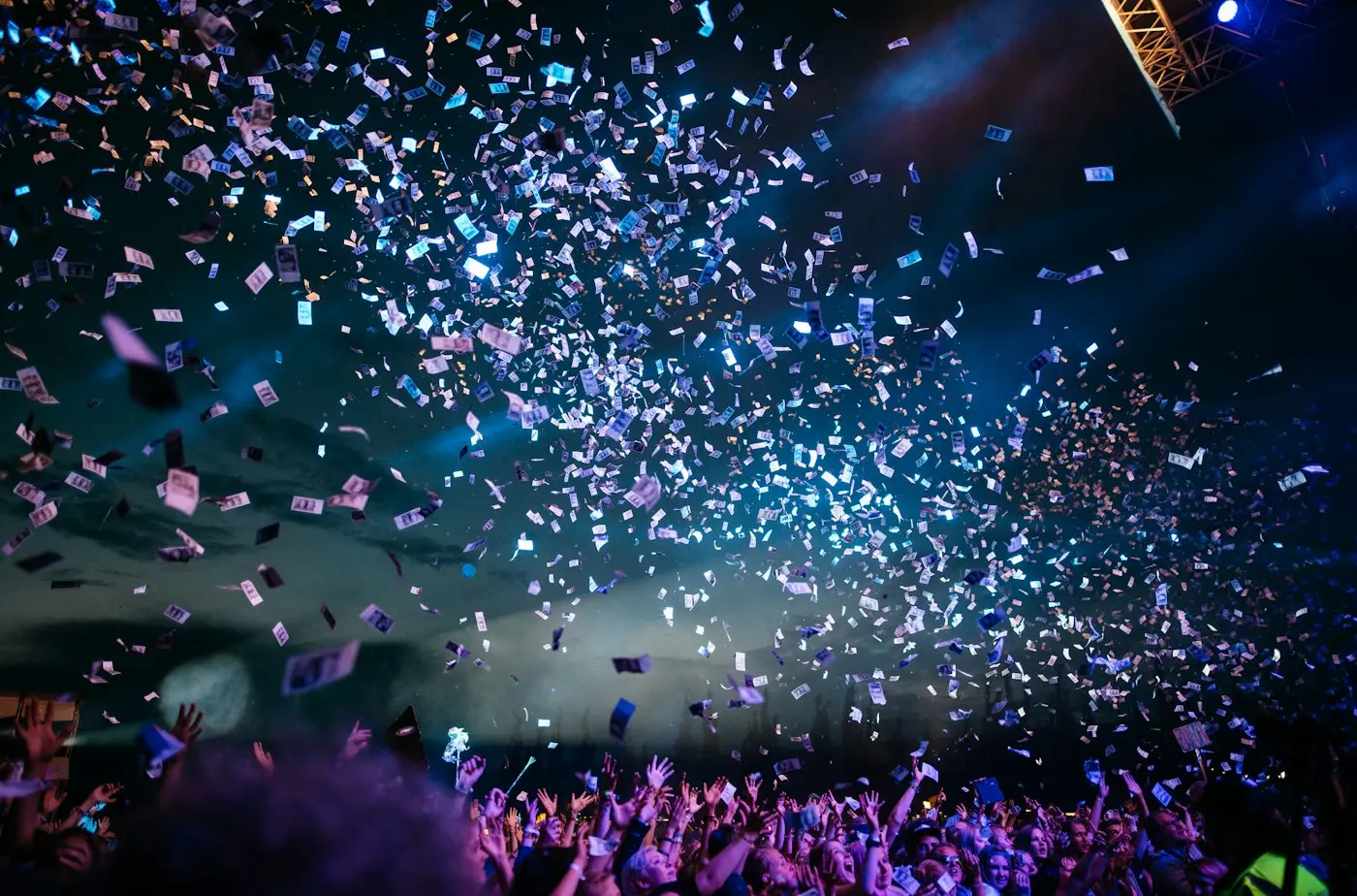 Confetti falling over a crowd at a celebration
